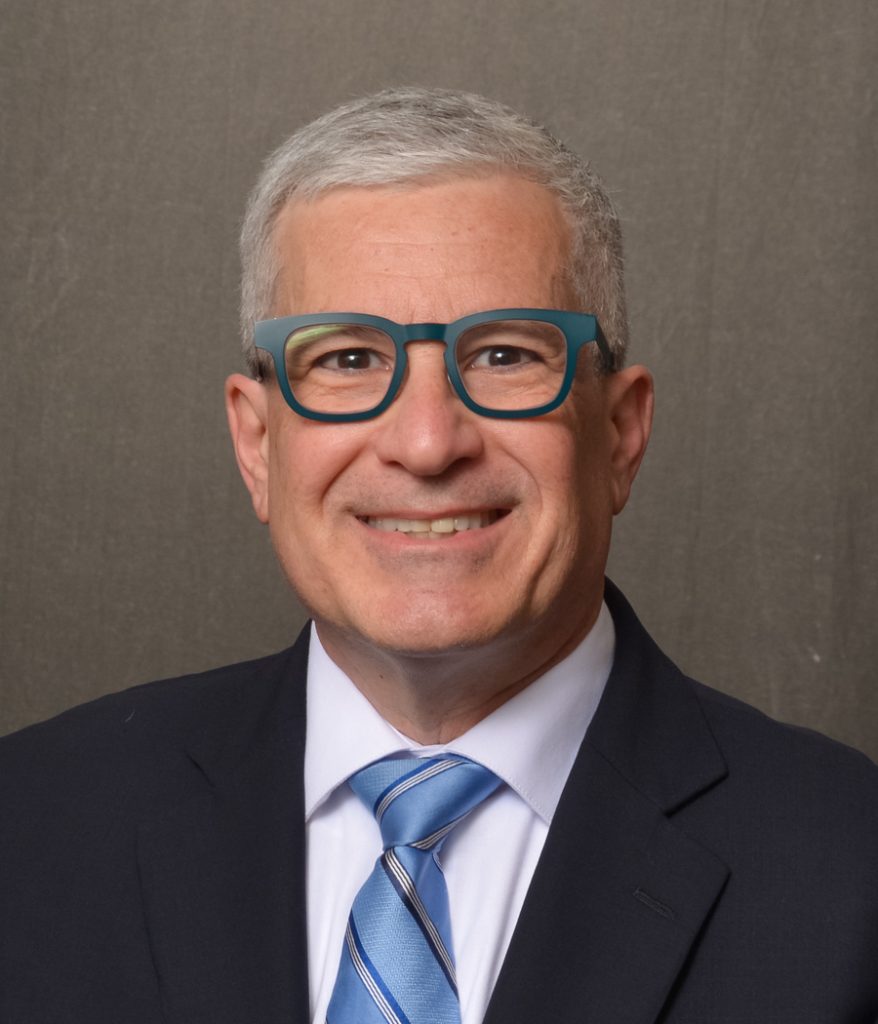 man wearing glasses and blue suit and neck tie