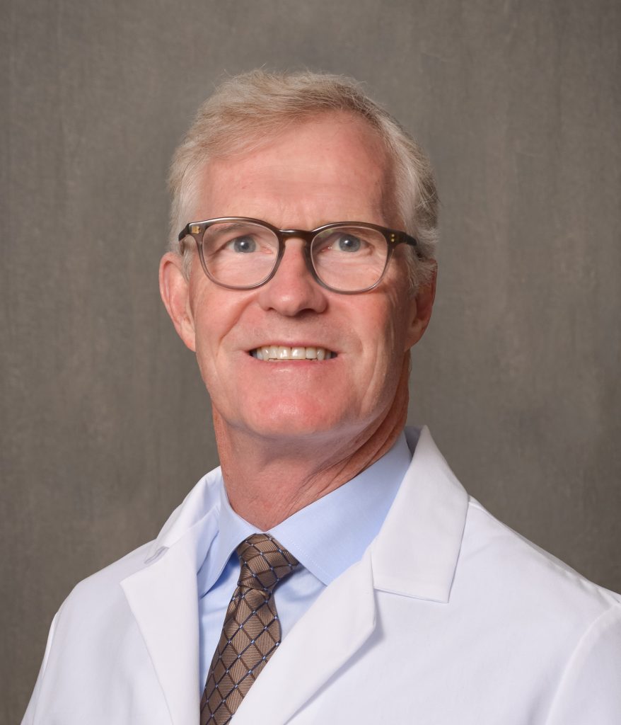 male physician with light hair and glasses