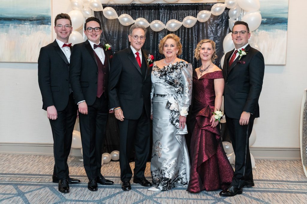 group of people in tuxes and gowns at a charity function