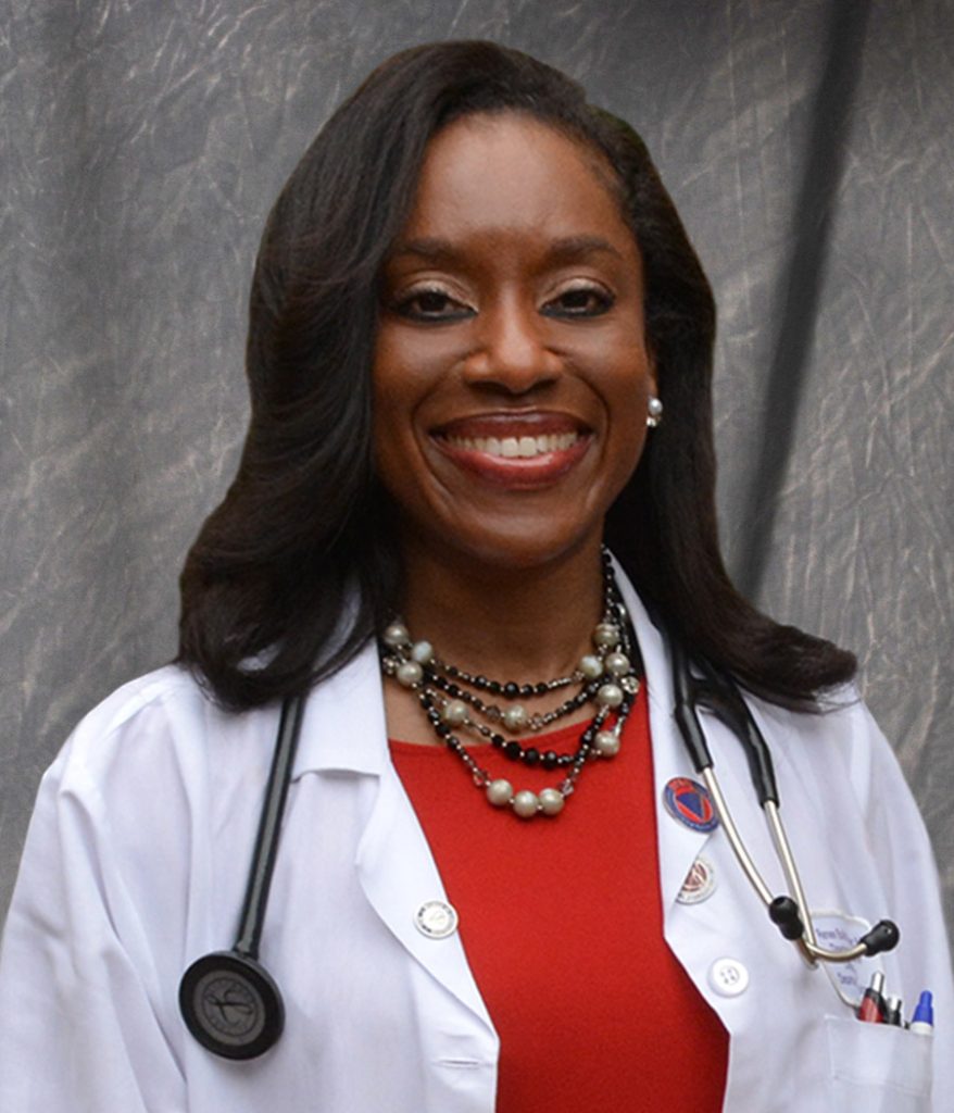black female physician wearing a red shirt, white lab coat and stethoscope arond her neck 