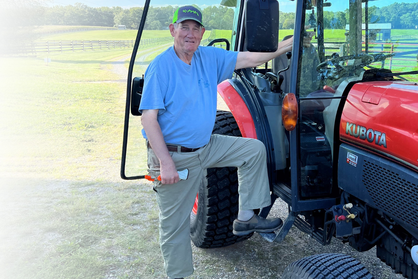 older male standing next to tractor