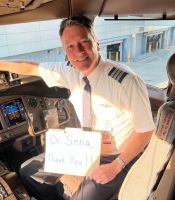 male pilot sitting in cockpit