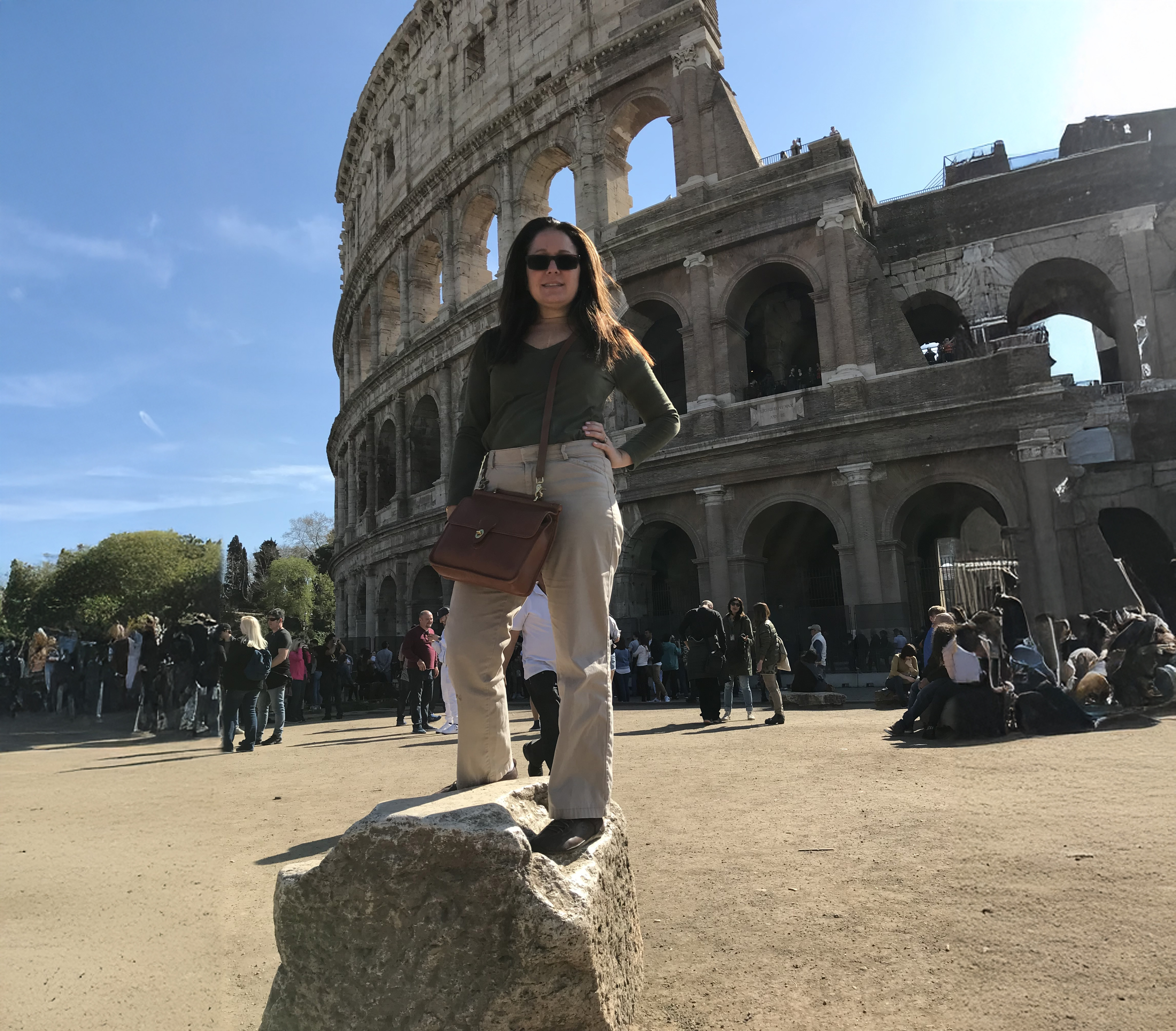 woman standing in front of colliseum